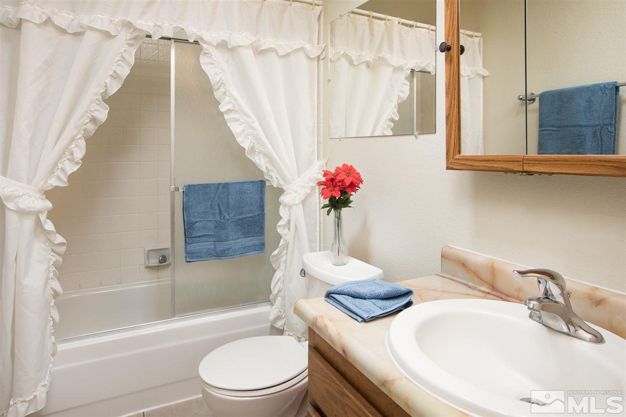 3933 Kings Row Reno, NV 89503 - Photo 10 of 25 a bathroom with a granite countertop sink and a mirror