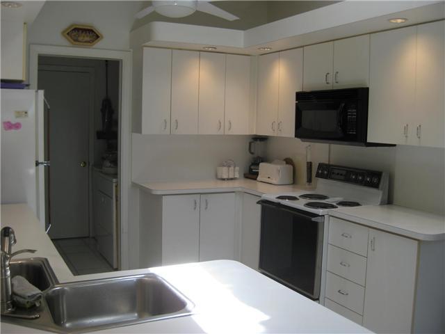 8548 Eagle Run Drive Boca Raton, FL 33434 - Photo 15 of 30 a kitchen with a sink cabinets and a stove top oven