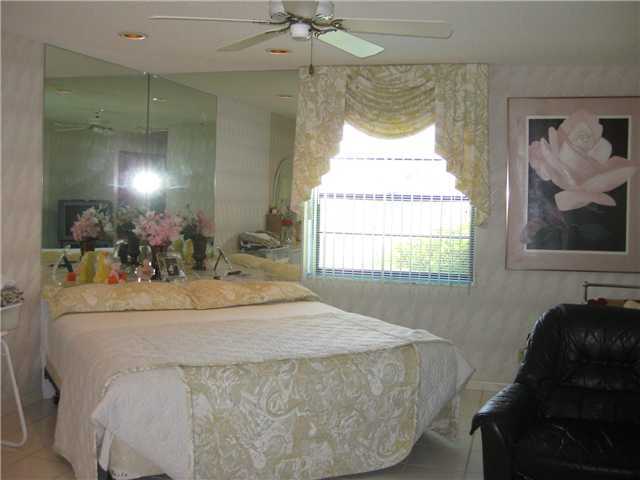 8548 Eagle Run Drive Boca Raton, FL 33434 - Photo 18 of 30 a bathroom with a granite countertop sink and a mirror
