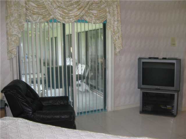 8548 Eagle Run Drive Boca Raton, FL 33434 - Photo 19 of 30 a living room with furniture and a fireplace