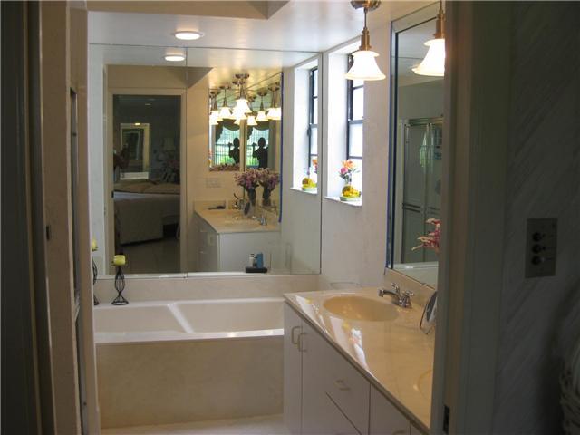 8548 Eagle Run Drive Boca Raton, FL 33434 - Photo 21 of 30 a bathroom with a tub a sink and mirror