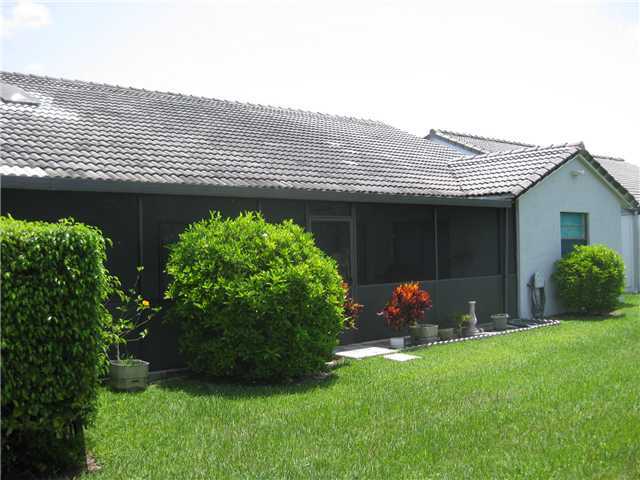 8548 Eagle Run Drive Boca Raton, FL 33434 - Photo 26 of 30 a backyard of a house with potted plants and a large tree