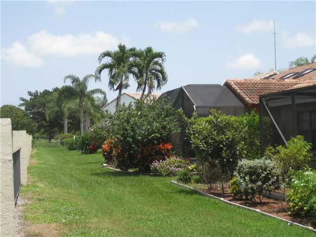 8548 Eagle Run Drive Boca Raton, FL 33434 - Photo 27 of 30 a front view of a house with a garden