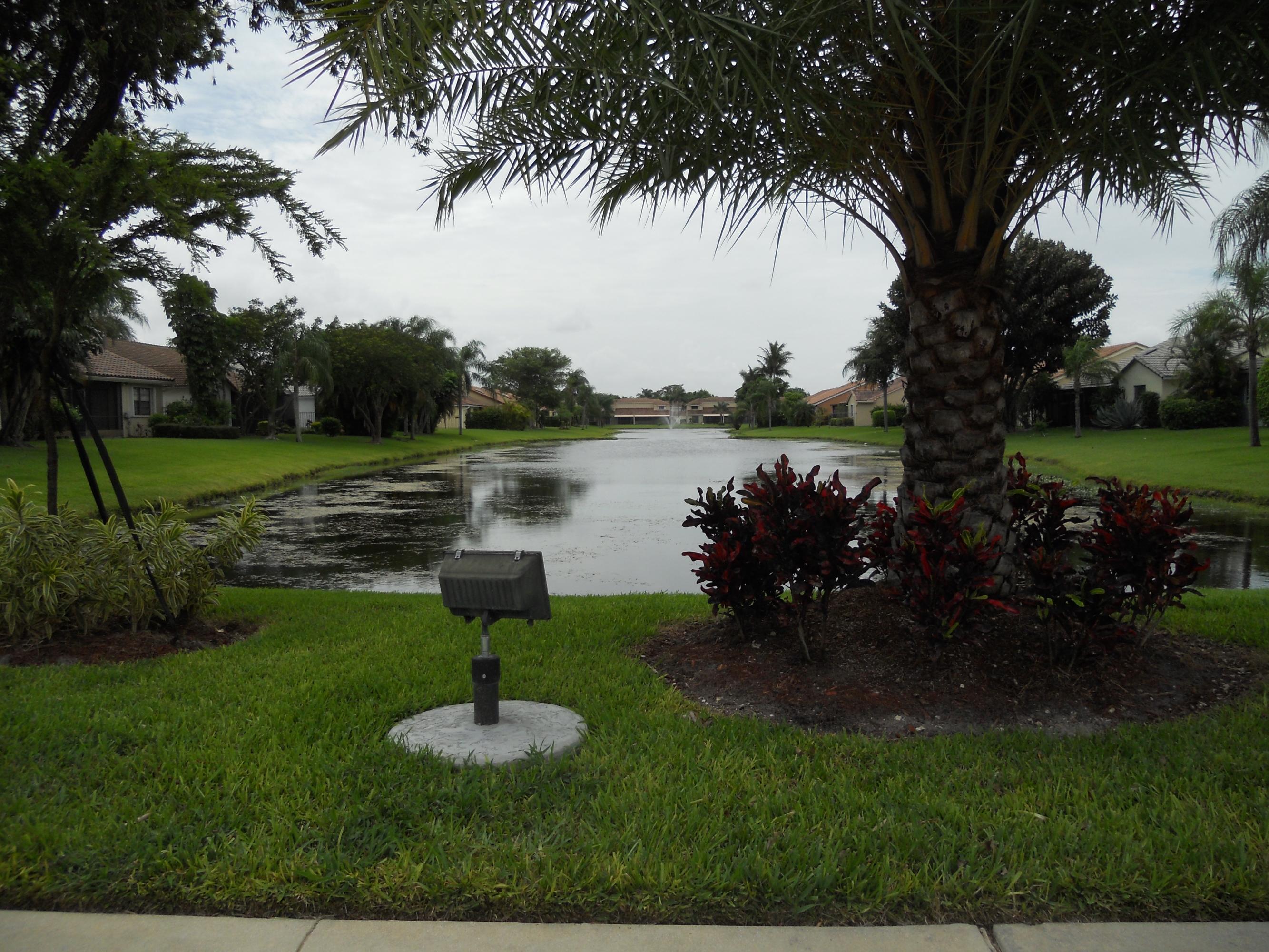 8548 Eagle Run Drive Boca Raton, FL 33434 - Photo 3 of 30 a lake view with a garden and trees