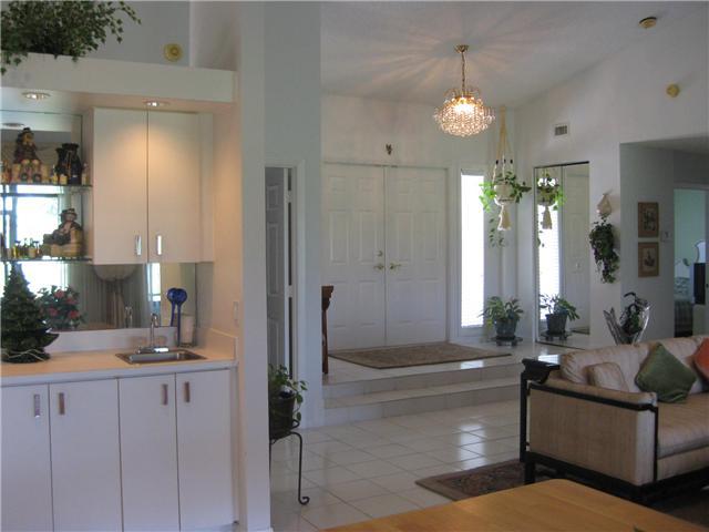 8548 Eagle Run Drive Boca Raton, FL 33434 - Photo 10 of 30 a living room with furniture and a chandelier