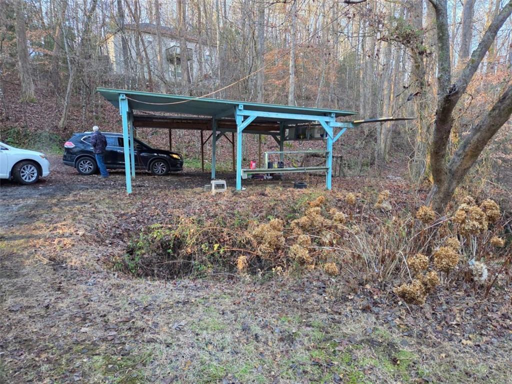 408 Apple Ridge 1 Dawsonville, GA 30534 - Photo 34 of 35 a view of a backyard with table and chairs under an umbrella