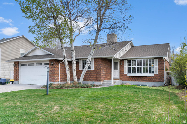 1822 East 9800th Street South Sandy, UT 84092 - Photo 2 of 38 View of front of property with roof with shingles, an attached garage, brick siding, concrete driveway, and a chimney