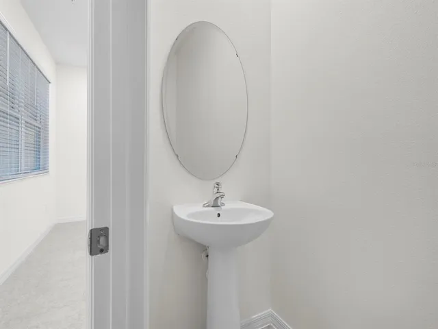 a bathroom with a sink a mirror and shower