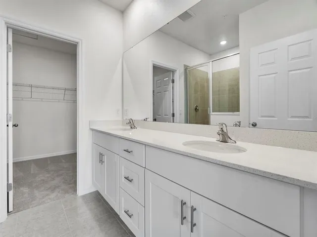 a bathroom with double sink and a mirror