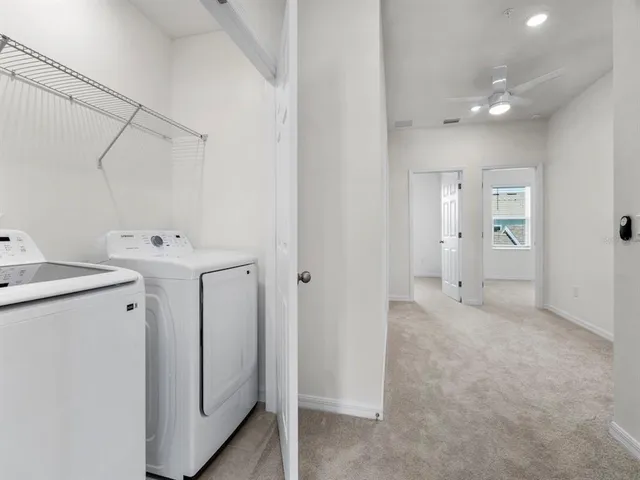 a view of a storage & utility room with a washer dryer