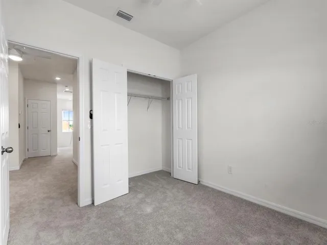 an empty room with closet area