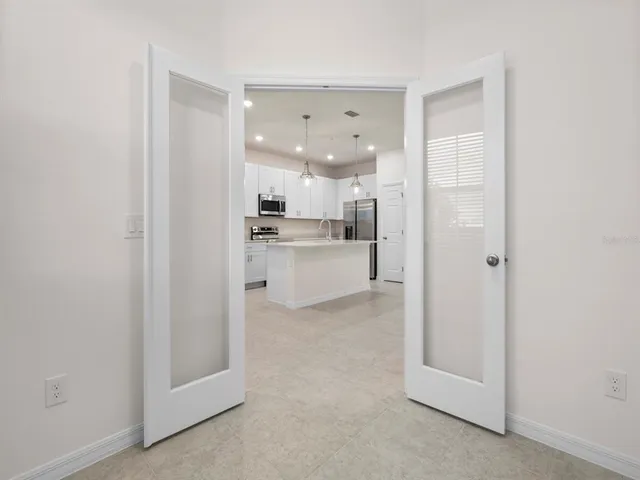 a view of a kitchen with a refrigerator and a sink