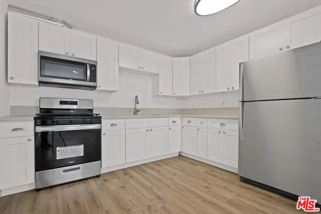 a bathroom with a toilet a sink a mirror and a bathtub