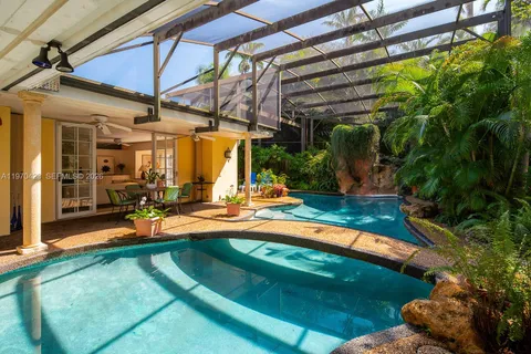 a view of a backyard with table and chairs under an umbrella