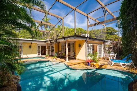 a view of a patio with a table and chairs under an umbrella