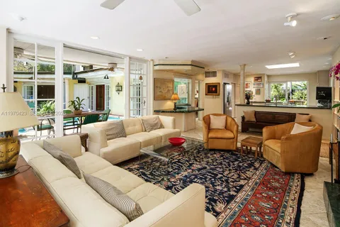 a living room with fireplace furniture and a large window