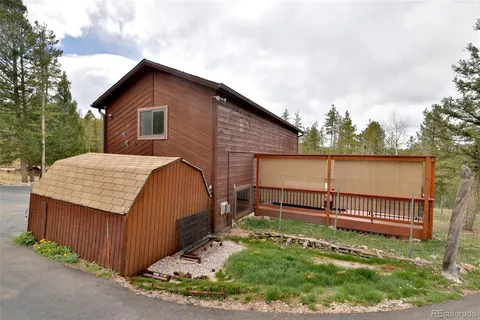 a view of backyard with a garden and deck