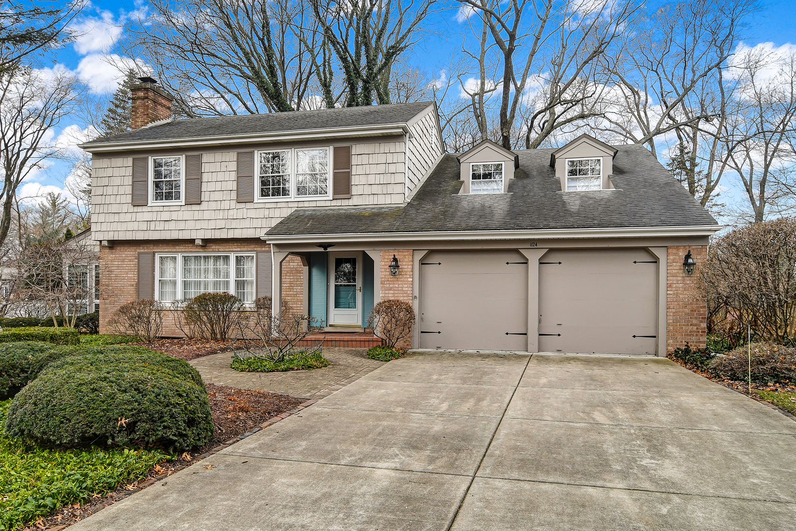 1124 Woodview Road Burr Ridge, IL 60527 - Photo 2 of 27 a front view of a house with garden