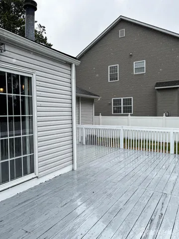 a view of a house with wooden deck