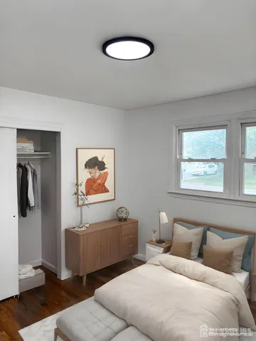 a bedroom with bed and a window