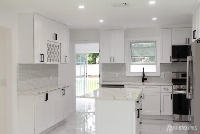 a kitchen with a sink a window and stainless steel appliances