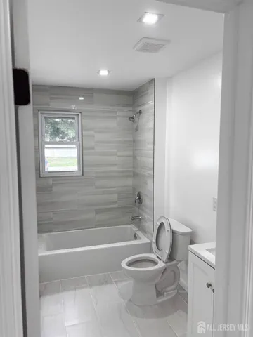 a bathroom with a toilet a sink and bathtub