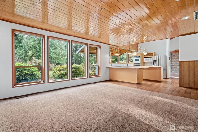 a view of a room with furniture and large windows