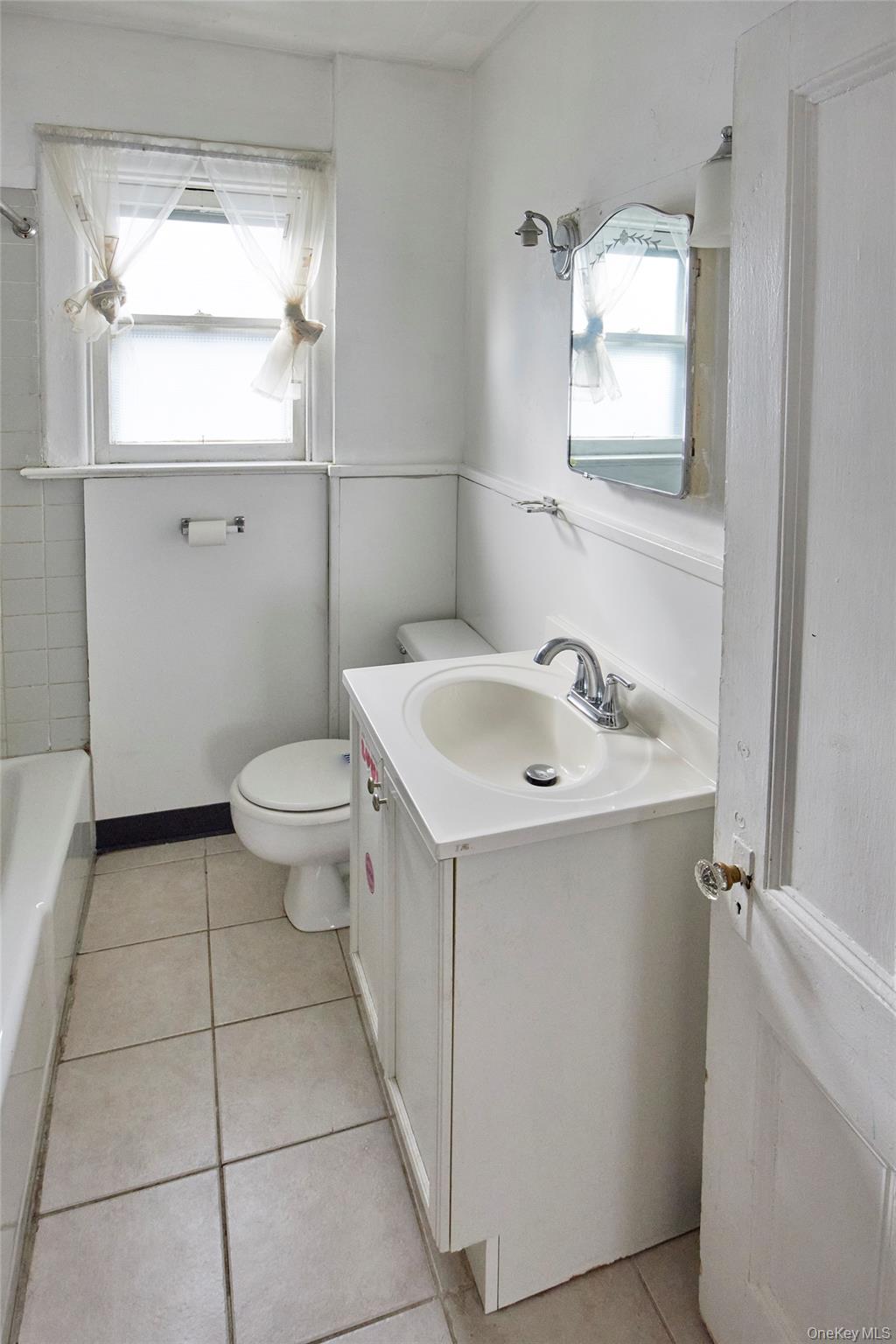 728 Frost Avenue Peekskill, NY 10566 - Photo 14 of 18 a bathroom with a sink a toilet and mirror
