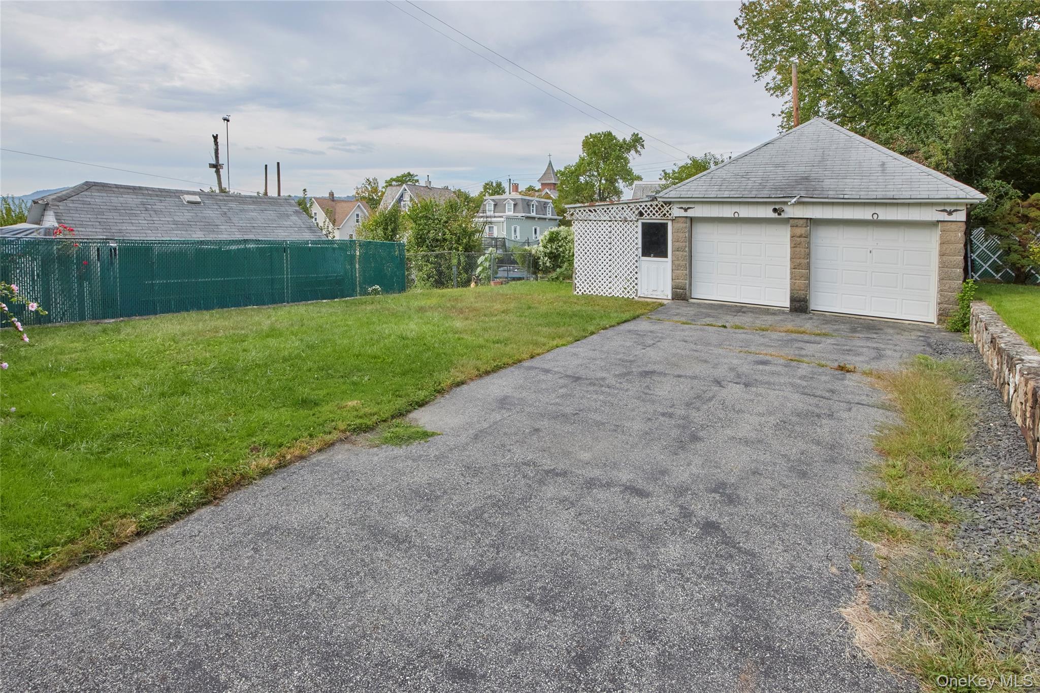 728 Frost Avenue Peekskill, NY 10566 - Photo 17 of 18 a view of a house with a yard and a garage
