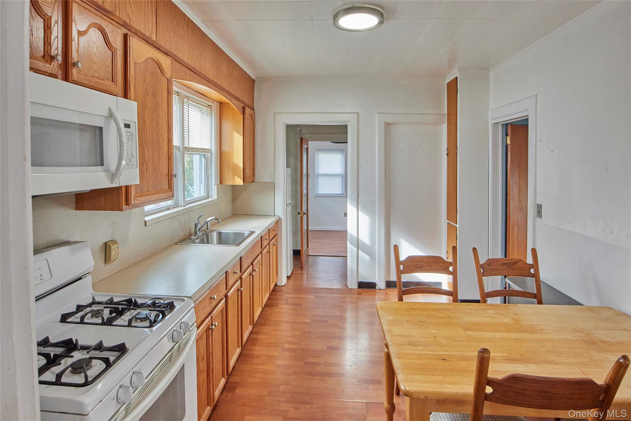 728 Frost Avenue Peekskill, NY 10566 - Photo 2 of 18 a kitchen with sink stove and wooden cabinets