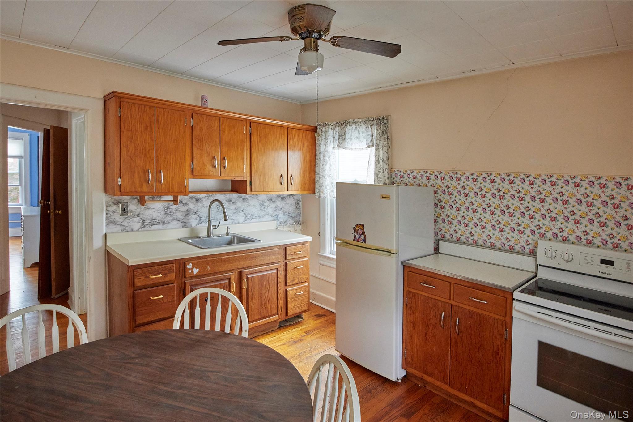 728 Frost Avenue Peekskill, NY 10566 - Photo 10 of 18 a kitchen with sink cabinets and window