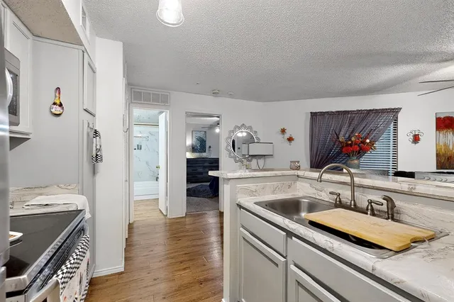 a kitchen with a sink appliances and cabinets