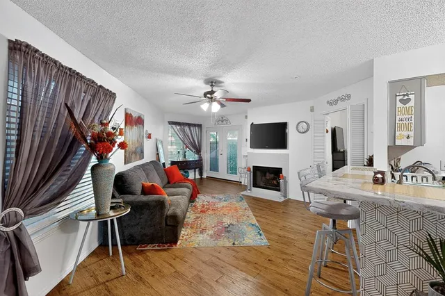 a living room with fireplace furniture and a flat screen tv