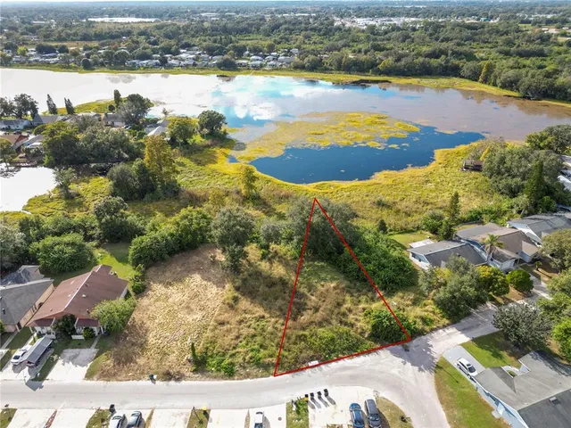an aerial view of residential houses with outdoor space and swimming pool