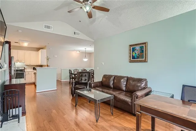 a living room with furniture and kitchen view