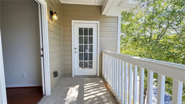 a view of a porch with wooden floor and fence