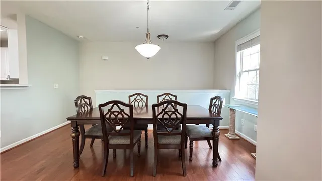a view of a dining room with furniture wooden floor and chandelier