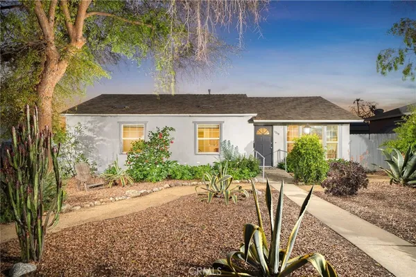a front view of a house with garden