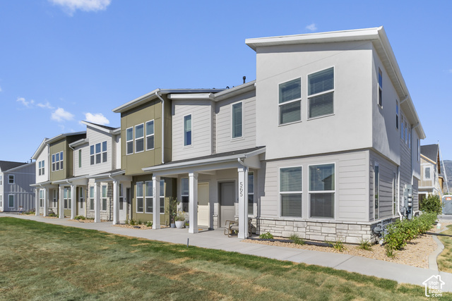 Contemporary architectural style featuring varied siding, stone accents, multiple windows, and covered front entryways