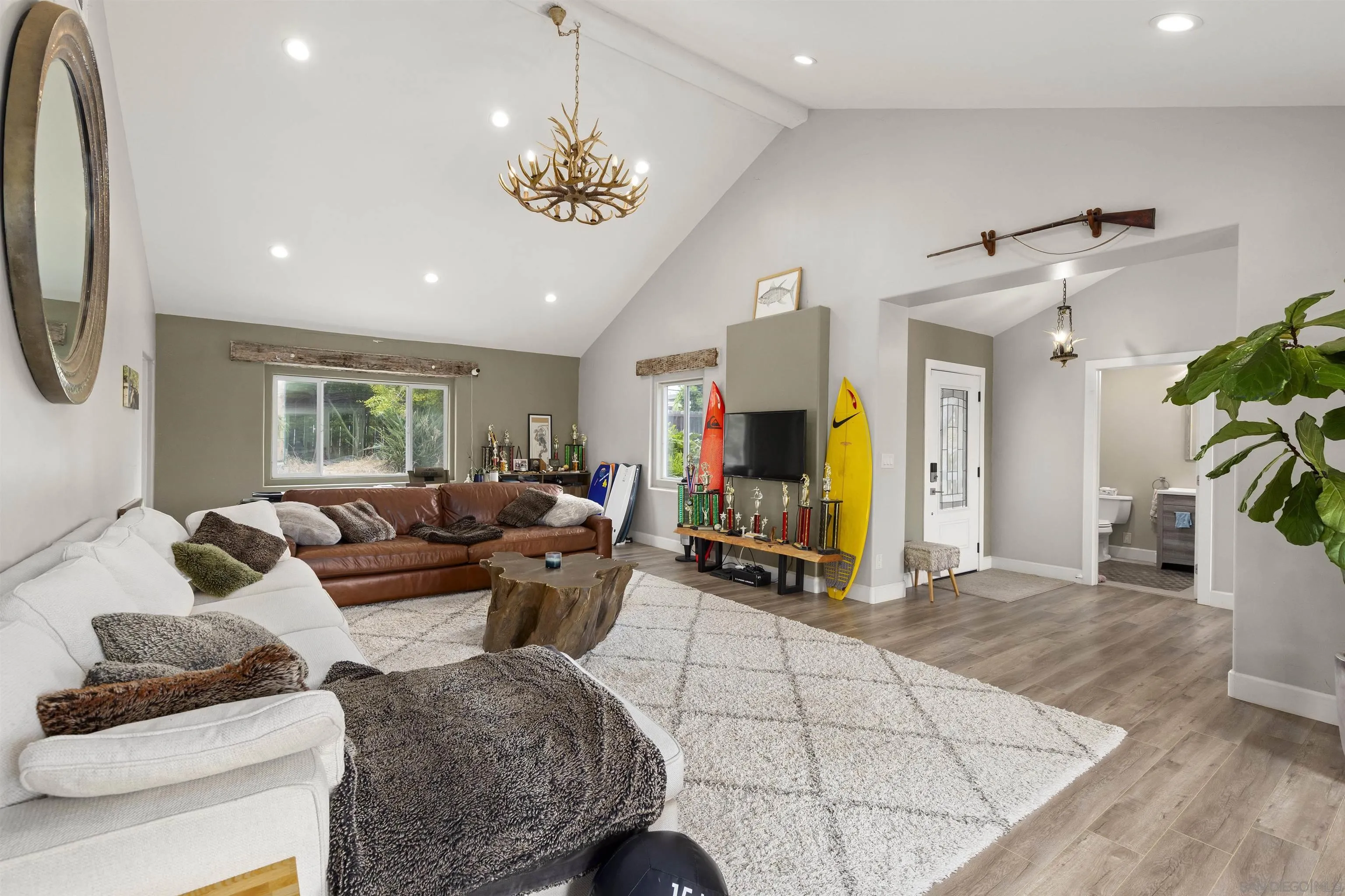 752 Bracero Road Encinitas, CA 92024 - Photo 12 of 46 a living room with furniture a dining table and a chandelier
