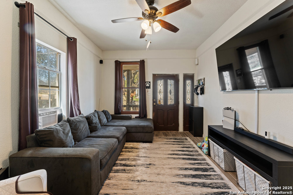 a living room with furniture and a flat screen tv