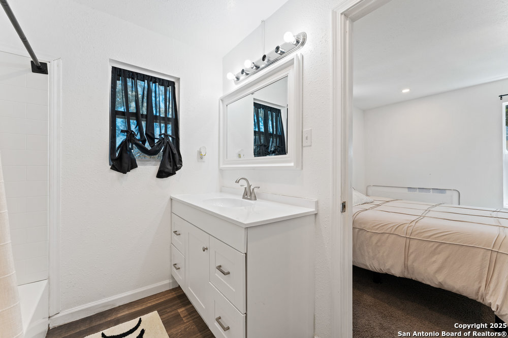 1410 Kayton Avenue San Antonio, TX 78210 - Photo 16 of 28 a en suite bathroom with a sink and a mirror