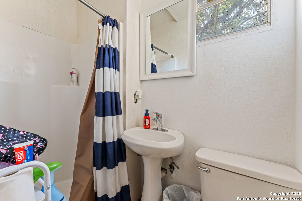 1410 Kayton Avenue San Antonio, TX 78210 - Photo 27 of 28 a bathroom with a sink toilet and a mirror