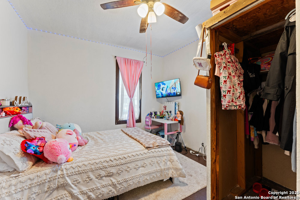 1410 Kayton Avenue San Antonio, TX 78210 - Photo 5 of 28 a bedroom with a bed and a chandelier