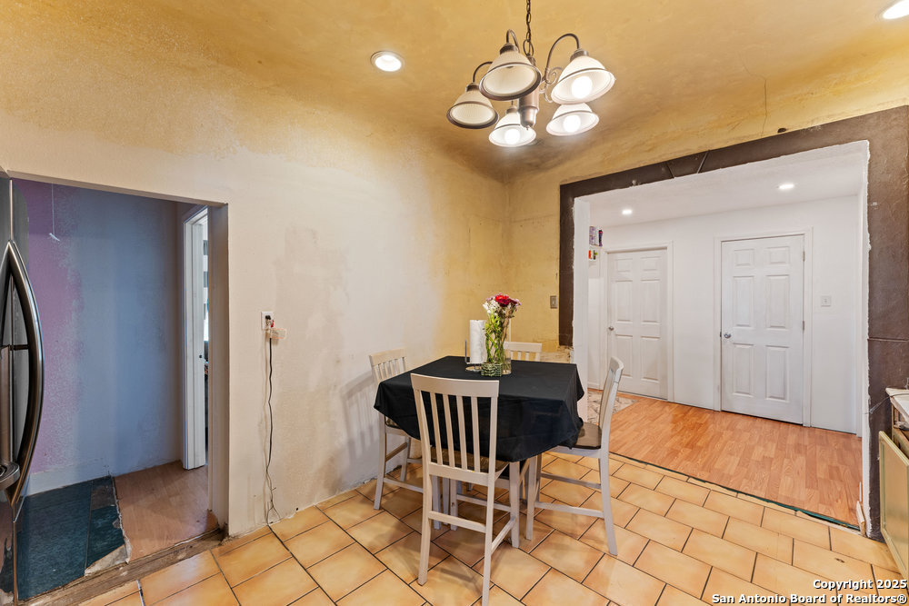 1410 Kayton Avenue San Antonio, TX 78210 - Photo 9 of 28 a view of a dining room with furniture and chandelier