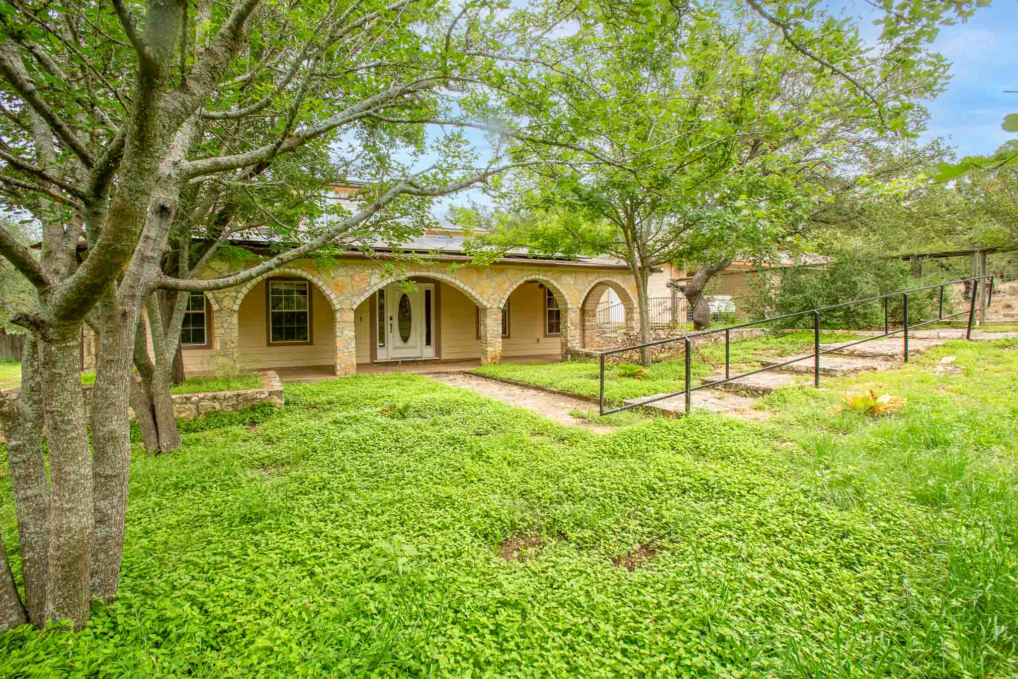 4525 Bell Springs Road Dripping Springs, TX 78620 - Photo 3 of 39 a view of a house with backyard and tree