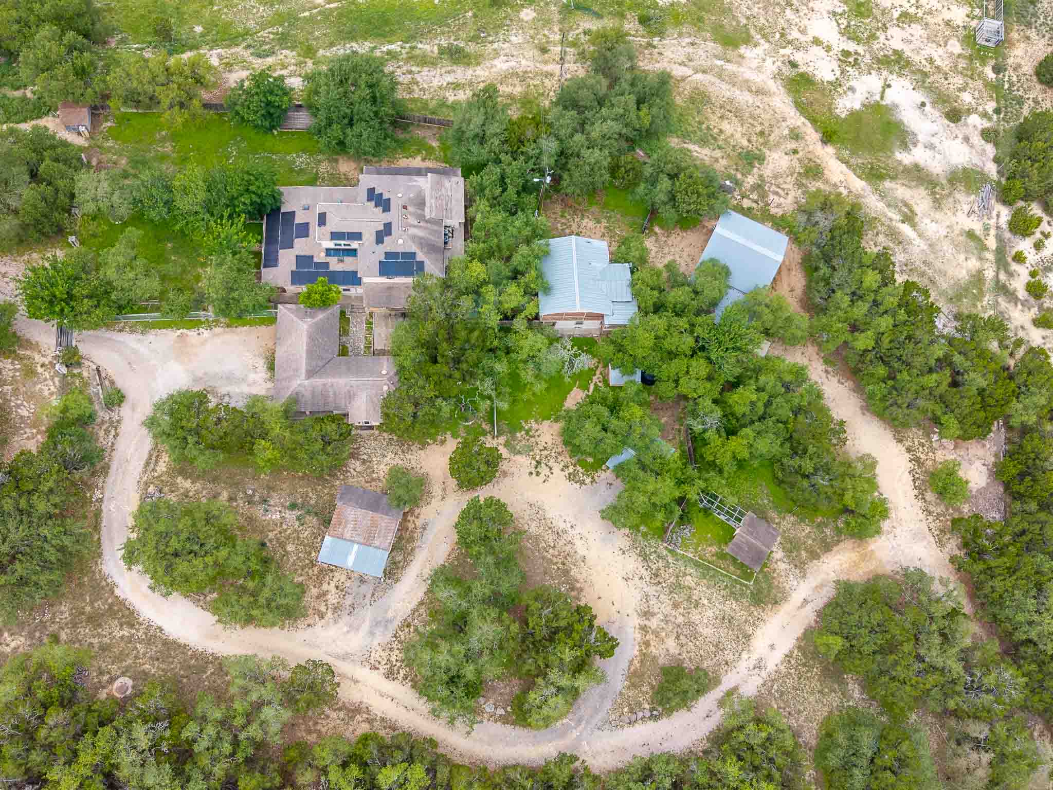 4525 Bell Springs Road Dripping Springs, TX 78620 - Photo 38 of 39 an aerial view of a house with a yard and lake