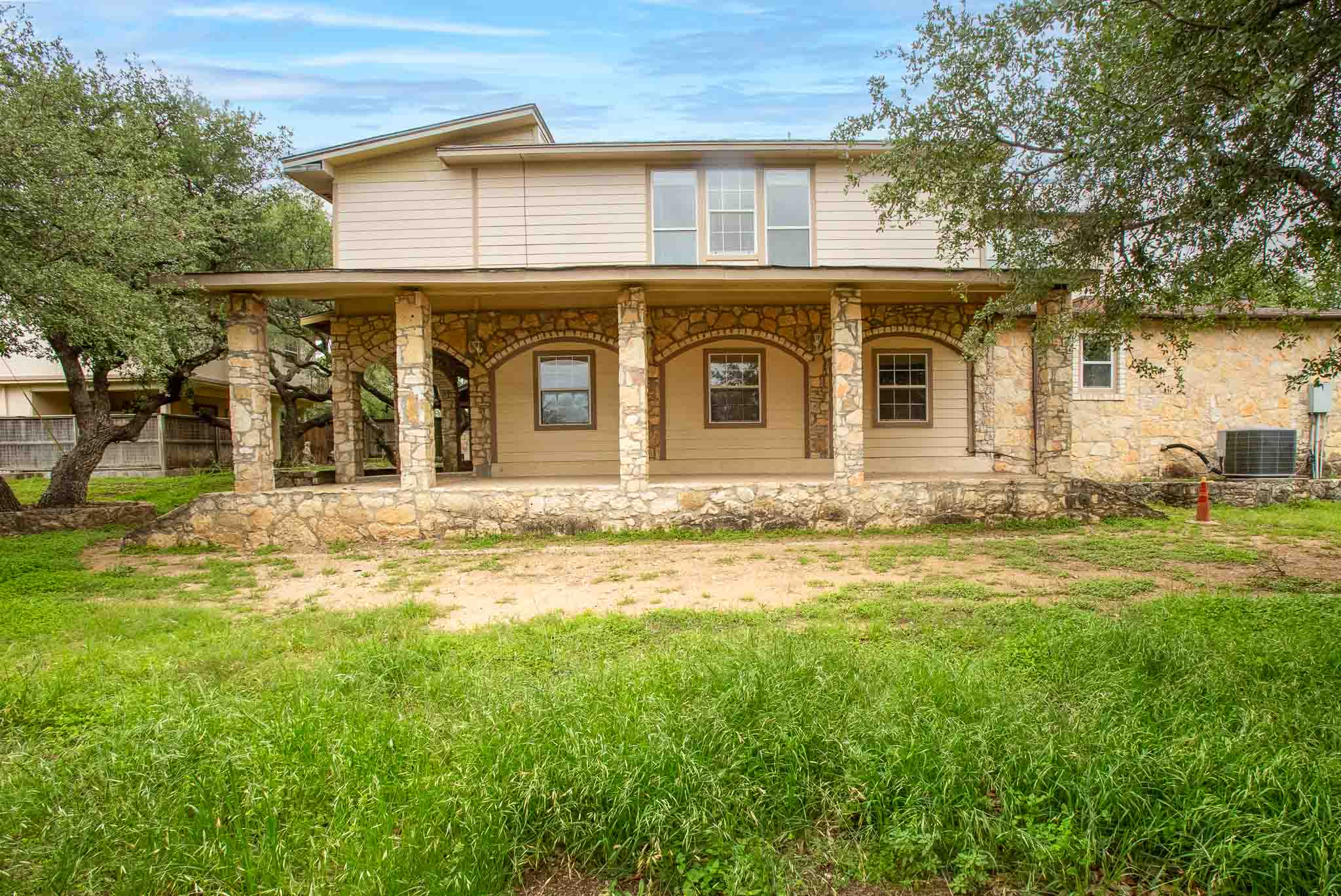 4525 Bell Springs Road Dripping Springs, TX 78620 - Photo 4 of 39 a front view of a house with garden