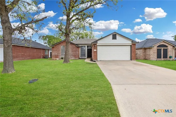 a front view of a house with yard