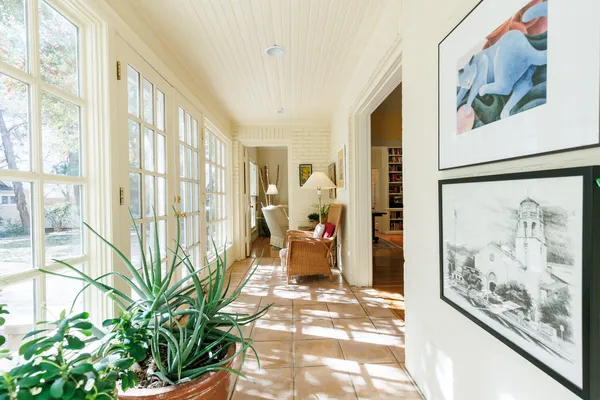 a kitchen with a refrigerator a stove a sink dishwasher and a dining table with wooden floor